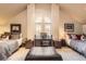 Spacious bedroom with vaulted ceilings and large arched windows, complete with beds and office area at 76 S Garfield St, Denver, CO 80209