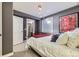 Modern bedroom with gray walls, white bedding, an en-suite bath, and stylish artwork on the wall at 76 S Garfield St, Denver, CO 80209
