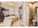 Elegant bathroom with a soaking tub, walk-in shower, and modern fixtures at 76 S Garfield St, Denver, CO 80209