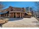 Exterior view of a commercial building with a restaurant entrance, wood piles, and outdoor seating at 76 S Garfield St, Denver, CO 80209