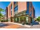Exterior view of a retail building with large glass windows, storefronts, and pedestrian walkways at 76 S Garfield St, Denver, CO 80209
