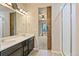 Dual vanity bathroom featuring modern fixtures, tiled floors and walk-in shower at 6049 Sandstone Cir, Erie, CO 80516