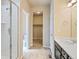 Modern bathroom featuring tiled shower, neutral colors, and tile flooring at 6049 Sandstone Cir, Erie, CO 80516