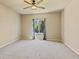 Spacious bedroom features a ceiling fan, neutral walls, and a window with natural light at 6049 Sandstone Cir, Erie, CO 80516