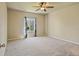 Bright bedroom featuring a ceiling fan, neutral walls, and a large window with natural light at 6049 Sandstone Cir, Erie, CO 80516