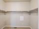 Walk-in closet with ample shelving, neutral paint, and carpet flooring at 6049 Sandstone Cir, Erie, CO 80516