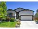 Well-maintained home with a spacious driveway and manicured landscaping at 6049 Sandstone Cir, Erie, CO 80516
