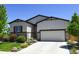 Inviting home exterior with a two-car garage and a well-kept lawn at 6049 Sandstone Cir, Erie, CO 80516