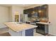 Modern kitchen featuring ample counter space, stainless steel appliances, and dark cabinets at 6049 Sandstone Cir, Erie, CO 80516