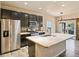 Contemporary kitchen with an island, stainless steel appliances, and a sliding barn door at 6049 Sandstone Cir, Erie, CO 80516
