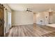 Spacious living room featuring modern light fixtures, plank flooring, and a rustic barn door at 6049 Sandstone Cir, Erie, CO 80516