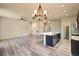 Open living space with hardwood floors and modern kitchen island at 6049 Sandstone Cir, Erie, CO 80516