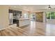 Open living and kitchen area with hardwood floors, stainless appliances, and barndoors at 6049 Sandstone Cir, Erie, CO 80516