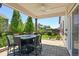 Covered patio with a ceiling fan and ample space for seating and entertaining at 6049 Sandstone Cir, Erie, CO 80516