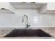 Close up view of the kitchen sink and white subway tile backsplash at 1700 Bassett St # 1803, Denver, CO 80202