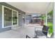 A covered back porch and fenced-in area featuring a sliding glass door and an entrance door at 9275 W Euclid Ave, Littleton, CO 80123