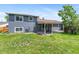 Manicured backyard with lush lawn, mature trees, and covered patio perfect for outdoor entertaining at 9275 W Euclid Ave, Littleton, CO 80123
