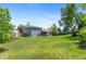 Expansive backyard with well-maintained lawn, mature trees, and covered patio for relaxing at 9275 W Euclid Ave, Littleton, CO 80123
