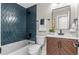 Stylish bathroom featuring a blue tiled accent wall, a modern vanity, and updated fixtures at 9275 W Euclid Ave, Littleton, CO 80123