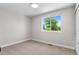 Bright bedroom with a large window providing natural light and neutral carpet at 9275 W Euclid Ave, Littleton, CO 80123