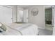 Bedroom showcasing a round mirror and an open doorway leading to an ensuite bathroom at 9275 W Euclid Ave, Littleton, CO 80123