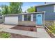 Close-up of a gray home featuring a white garage door and a striking blue front door at 9275 W Euclid Ave, Littleton, CO 80123