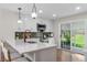 Stylish kitchen with white countertops, sleek appliances, and sliding door access to the backyard at 9275 W Euclid Ave, Littleton, CO 80123