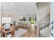 Open-concept living space featuring wood floors, modern decor, and a view of the kitchen at 9275 W Euclid Ave, Littleton, CO 80123