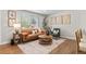 Cozy living room showcasing hardwood floors, a large window, and comfortable seating at 9275 W Euclid Ave, Littleton, CO 80123