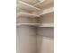 This is a walk-in closet with built-in shelving creating ample storage and organization at 10792 E Exposition Ave # 353, Aurora, CO 80012