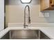 Close-up of kitchen sink with faucet and white quartz countertop at 10792 E Exposition Ave # 353, Aurora, CO 80012