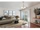 Bright living room with neutral tones, modern decor, and sliding door access to the outside at 10792 E Exposition Ave # 353, Aurora, CO 80012