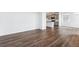 Open-concept living space with wood floors seamlessly connecting to the kitchen at 28621 E 8Th St, Watkins, CO 80137