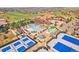 Aerial view of the community amenities including a clubhouse, pool, and tennis courts at 8204 S Vandriver Way, Aurora, CO 80016