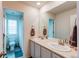 Bright bathroom featuring a double sink vanity and a full bath/shower combo at 8204 S Vandriver Way, Aurora, CO 80016