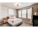 Cozy bedroom featuring three bright windows, a ceiling fan, and neutral walls creating a relaxing retreat at 8204 S Vandriver Way, Aurora, CO 80016