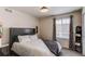 Neutral bedroom featuring a window, and warm colors creating a comforting and stylish ambiance at 8204 S Vandriver Way, Aurora, CO 80016