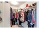 Walk-in closet with shelving and hanging racks offering ample storage space for an organized wardrobe at 8204 S Vandriver Way, Aurora, CO 80016