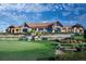 Exterior shot of the community clubhouse overlooking a manicured lawn at 8204 S Vandriver Way, Aurora, CO 80016