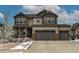 Charming two-story home showcasing a three car garage, covered porch, and beautiful neutral-colored siding at 8204 S Vandriver Way, Aurora, CO 80016