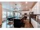 Bright kitchen and dining area featuring a large island with seating and ample space for Gathering gatherings at 8204 S Vandriver Way, Aurora, CO 80016