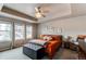 Serene main bedroom with a tray ceiling, large windows, and stylish decor, creating a relaxing retreat at 8204 S Vandriver Way, Aurora, CO 80016