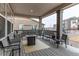 Covered patio seating area with multiple chairs, benches, and a small table at 8204 S Vandriver Way, Aurora, CO 80016