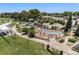 Aerial shot showcasing a Gathering-friendly splash pad and playground surrounded by lush green spaces and mature trees at 8675 W 60Th Ave, Arvada, CO 80004