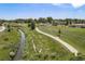 A beautiful shot of a creek and park with walking trails and a recreational park with a covered area at 8675 W 60Th Ave, Arvada, CO 80004