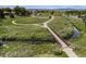 Scenic aerial shot showcasing a walking bridge with beautiful landscaping and walking paths on either side of a stream at 8675 W 60Th Ave, Arvada, CO 80004