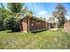 Cozy brick home featuring a spacious backyard with a well-maintained lawn and charming pergola-covered patio at 8675 W 60Th Ave, Arvada, CO 80004