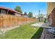 Backyard view features a shed, patio, and green lawn at 8675 W 60Th Ave, Arvada, CO 80004