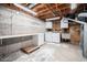 Unfinished basement with laundry area, shelving, and concrete walls at 8675 W 60Th Ave, Arvada, CO 80004