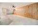 Large basement area with wooden paneling and built-in shelving at 8675 W 60Th Ave, Arvada, CO 80004
